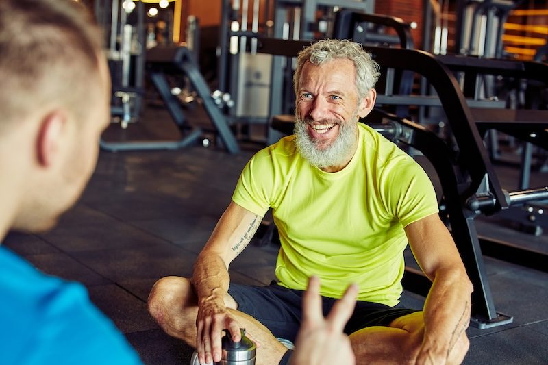 happy-middle-aged-man-discussing-something-with-fi-2023-11-27-05-30-12-utc.jpg